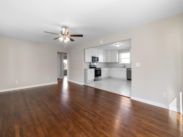  living room featuring ceiling fan, dark hardwood / wood-style flooring, and sink