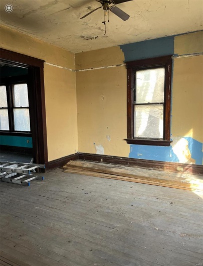Empty room with ceiling fan and hardwood / wood-style floors