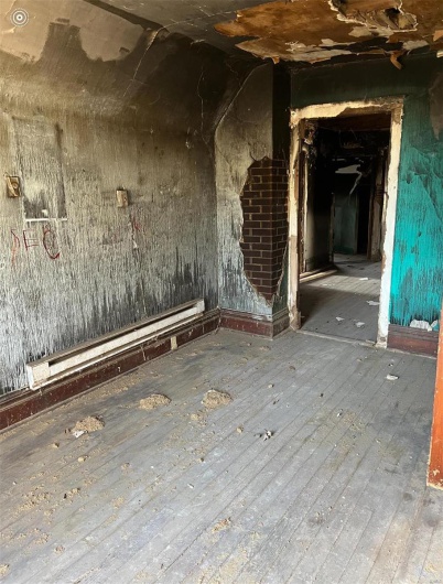 Misc room with hardwood / wood-style floors and a baseboard radiator
