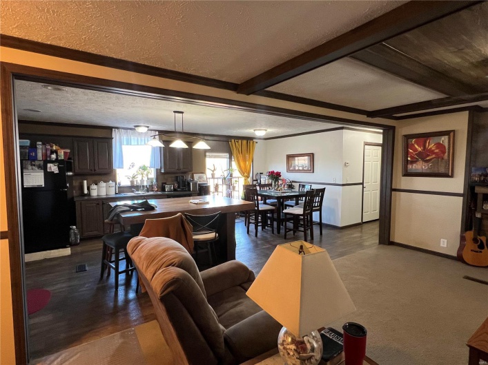 Living room with a textured ceiling and beam ceiling