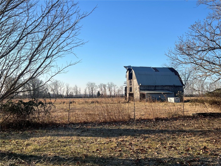 View of yard with an outdoor structure and a rural view