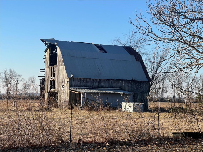 View of side of property with an outdoor structure