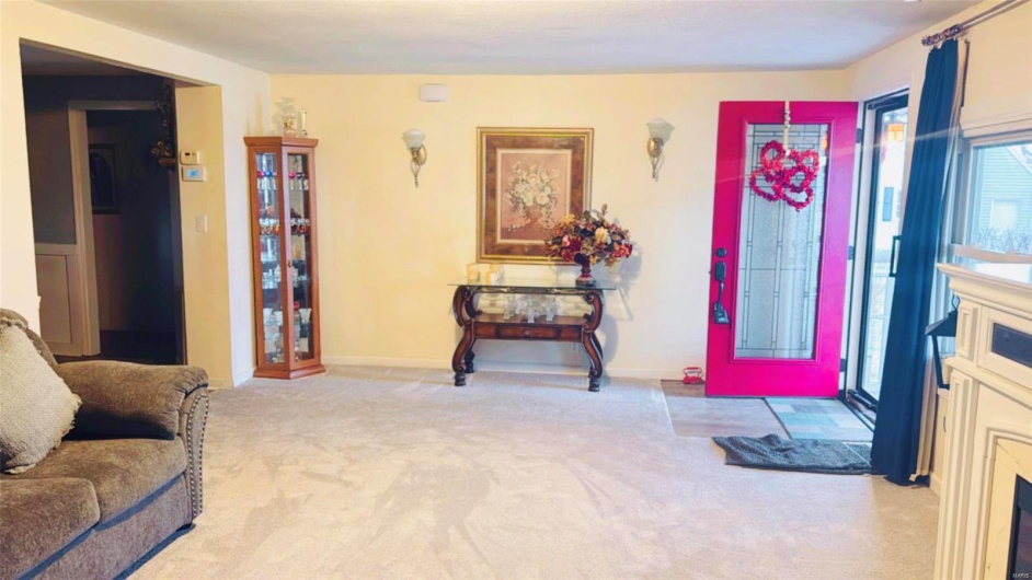 Foyer featuring light colored carpet