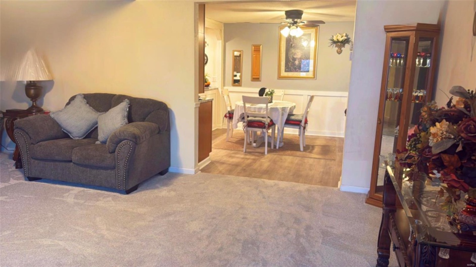 Living room with light carpet and ceiling fan