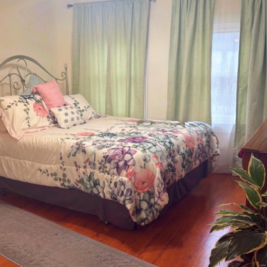 Bedroom with hardwood / wood-style floors