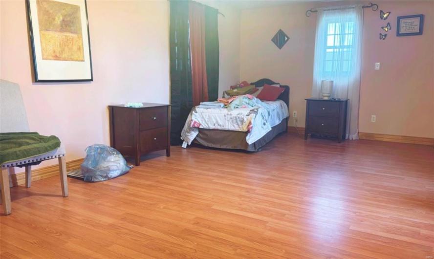 Bedroom with light hardwood / wood-style floors