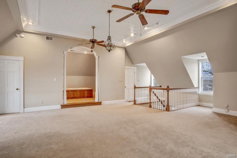Bonus room with lofted ceiling, carpet floors, and ceiling fan