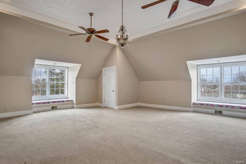 Additional living space with ceiling fan, lofted ceiling, and carpet floors