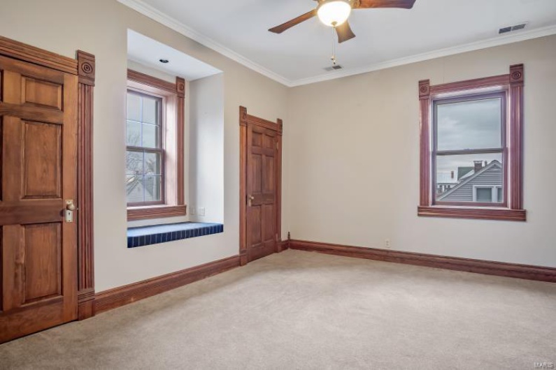 Unfurnished room featuring crown molding, ceiling fan, and carpet flooring