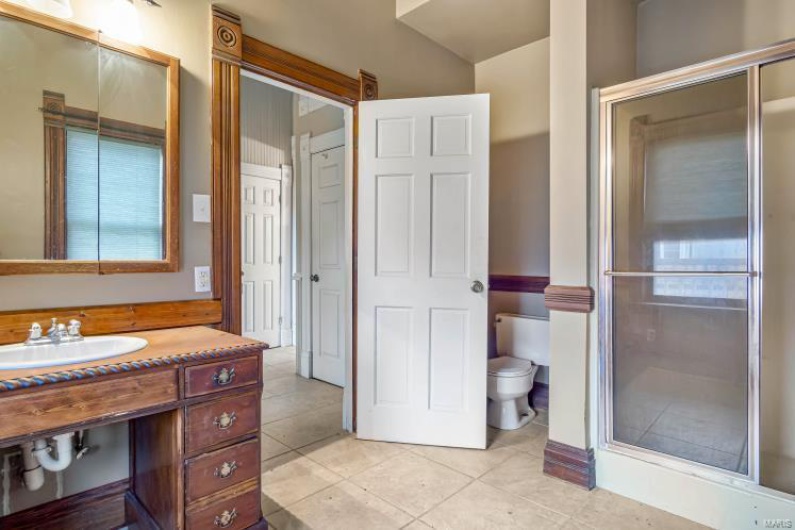 Bathroom featuring tile patterned flooring, vanity, and toilet