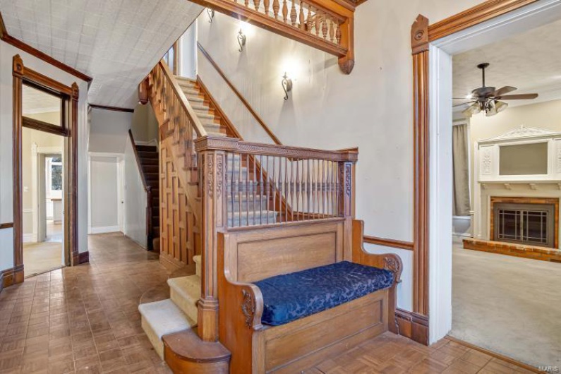 Staircase with crown molding, parquet flooring, and ceiling fan