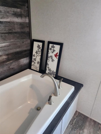 Bathroom featuring hardwood / wood-style floors, a bathtub, and sink