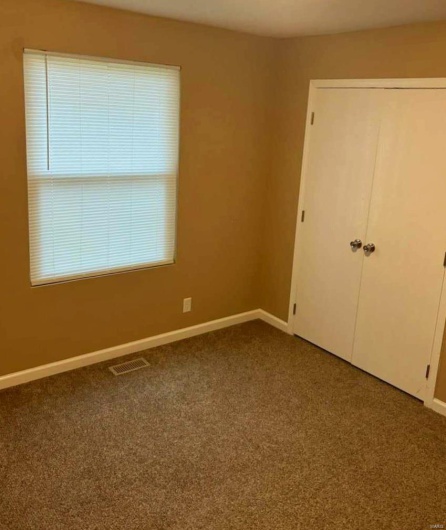 Unfurnished bedroom featuring a closet and carpet