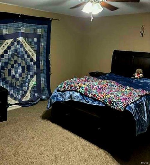 Bedroom with ceiling fan and carpet
