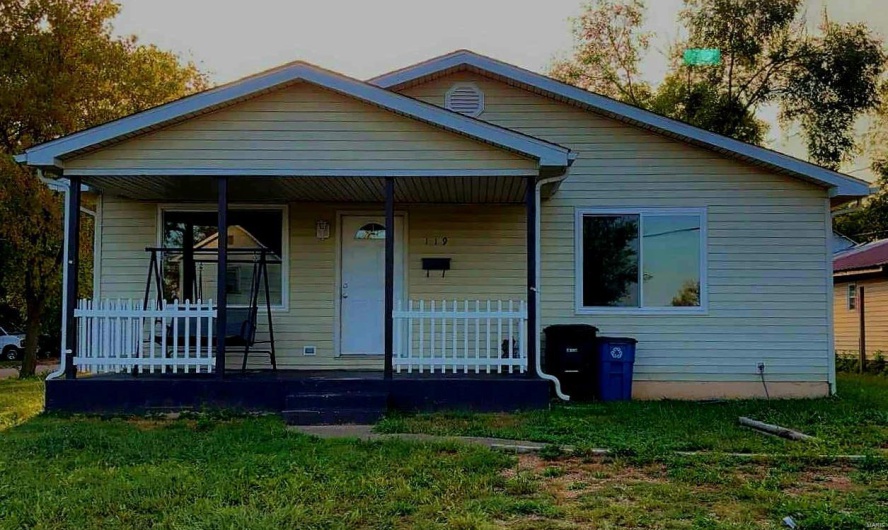 Bungalow-style home featuring a front yard and covered porch
