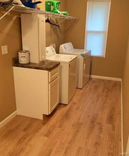 Laundry room featuring light hardwood / wood-style floors and washer and dryer
