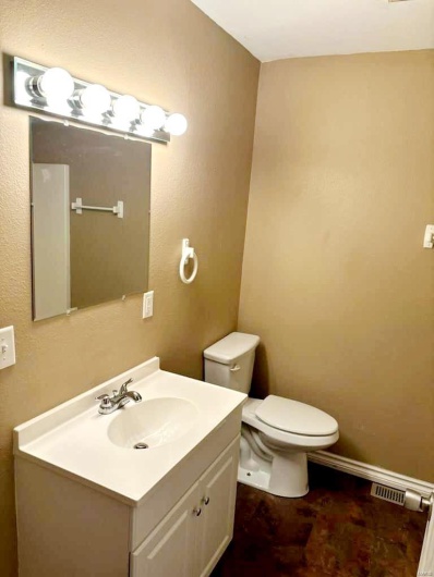 Bathroom featuring vanity and toilet