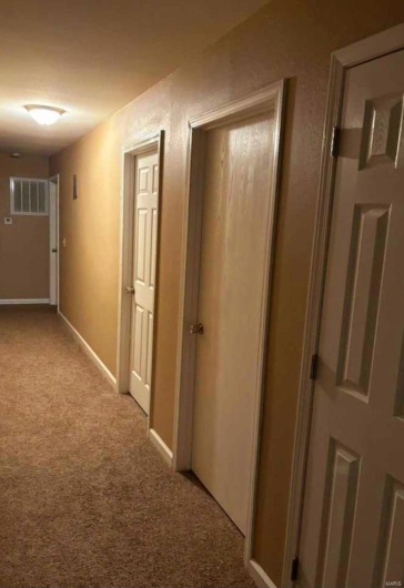 Hallway with light colored carpet