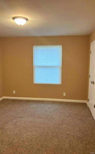 Spare room featuring carpet
