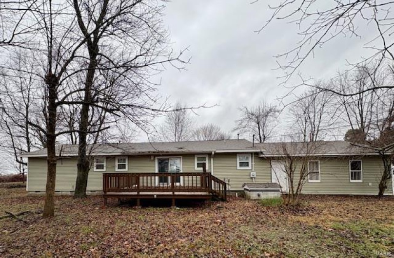 Rear view of house featuring a wooden deck