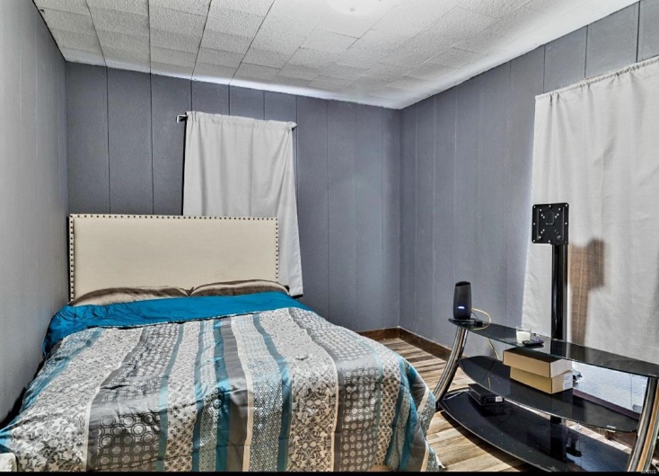 Bedroom with wood-type flooring