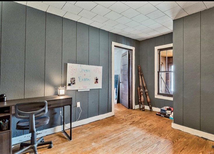 Home office with light hardwood / wood-style floors