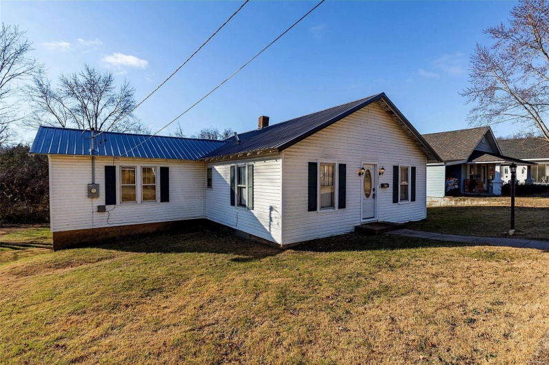 View of side of property with a yard