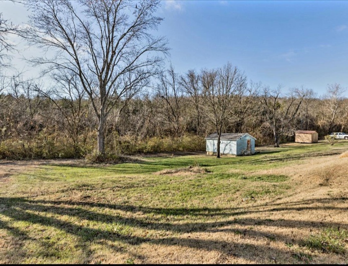View of yard with a storage shed