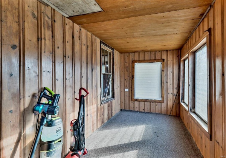 Unfurnished sunroom featuring wooden ceiling