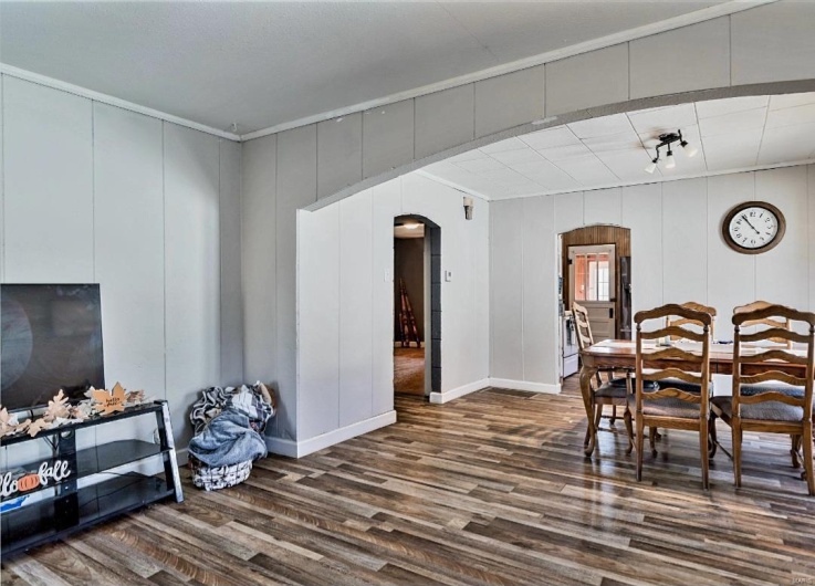 Dining room featuring wood-type flooring and ornamental molding