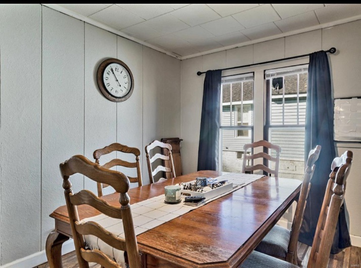 Dining area with hardwood / wood-style flooring