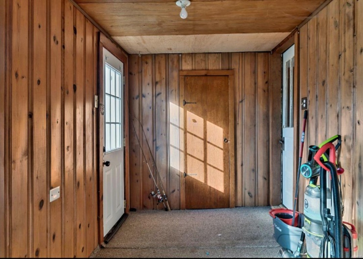 Misc room featuring carpet flooring, wooden walls, and wooden ceiling