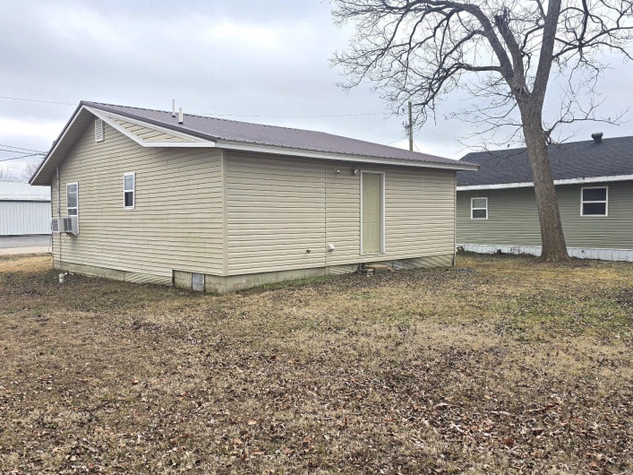 View of side of home featuring cooling unit