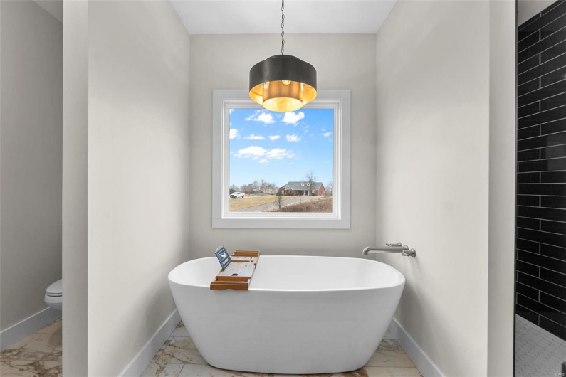 Bathroom with a tub to relax in and toilet