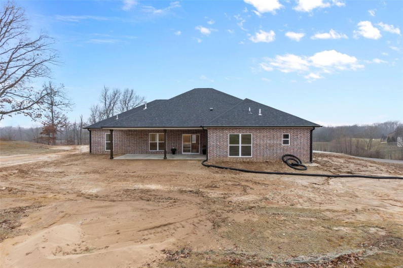 Rear view of house featuring a patio area