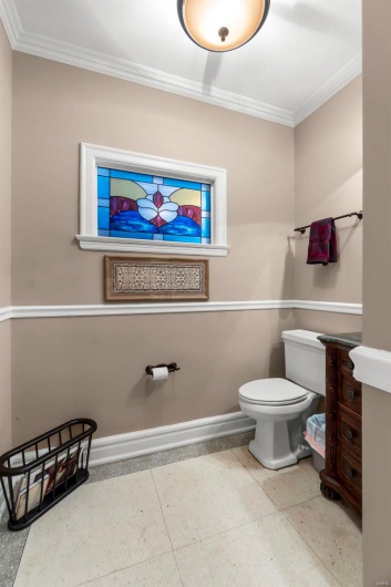 Bathroom with ornamental molding and toilet