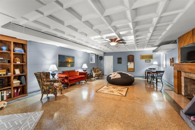 Living room with beamed ceiling, ceiling fan, and coffered ceiling
