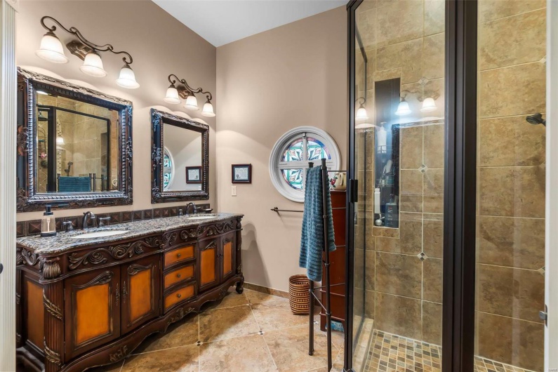 Bathroom featuring an enclosed shower and vanity