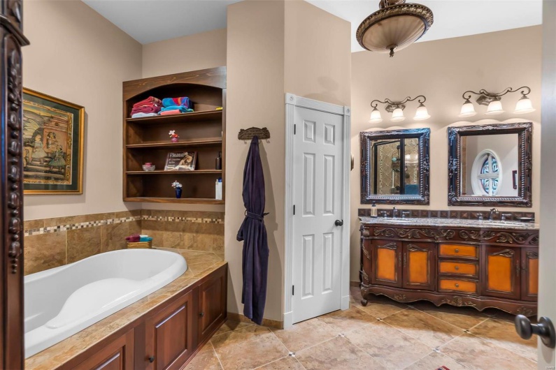 Bathroom with vanity, a tub, and tile patterned floors
