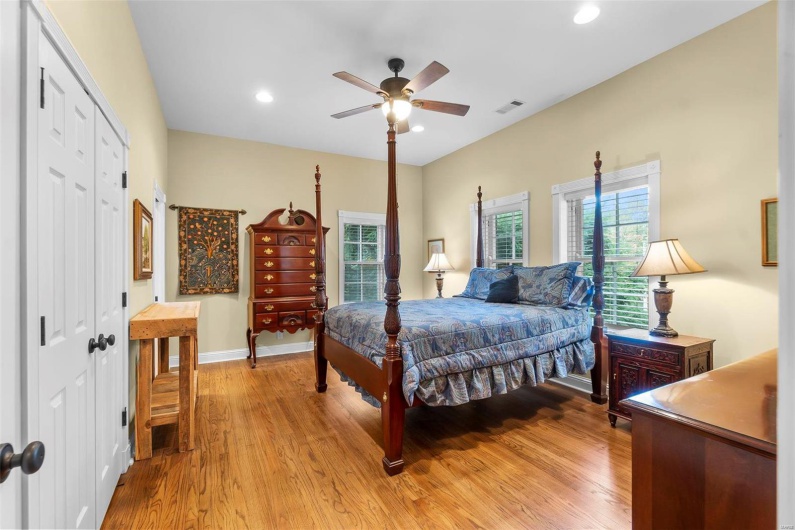 Bedroom featuring ceiling fan, light hardwood / wood-style floors, and a closet
