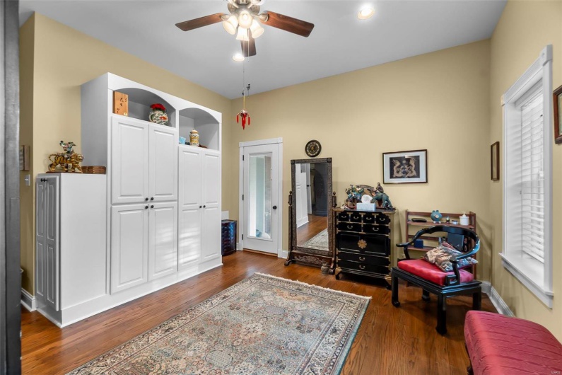 Sitting room featuring ceiling fan and dark hardwood / wood-style flooring