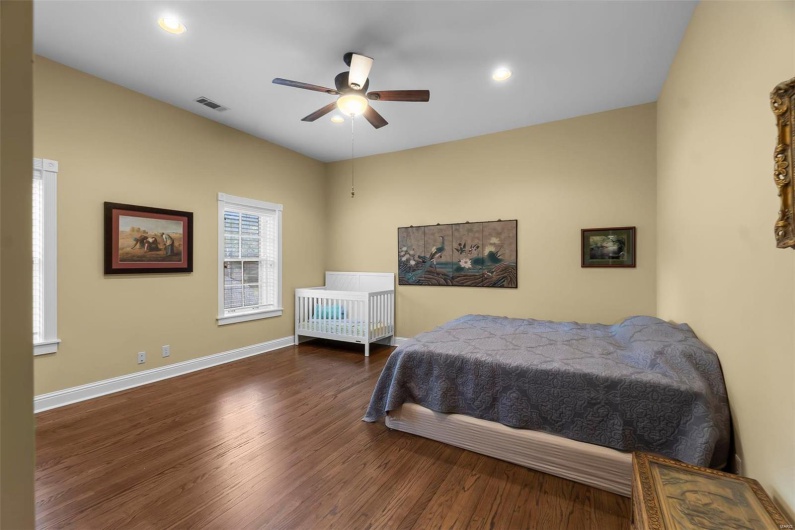 Bedroom featuring dark hardwood / wood-style floors and ceiling fan