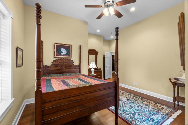 Bedroom with dark hardwood / wood-style flooring and ceiling fan