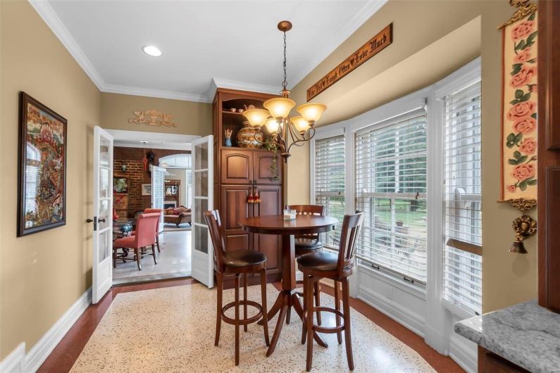 Dining room featuring an inviting chandelier, hardwood / wood-style floors, and ornamental molding