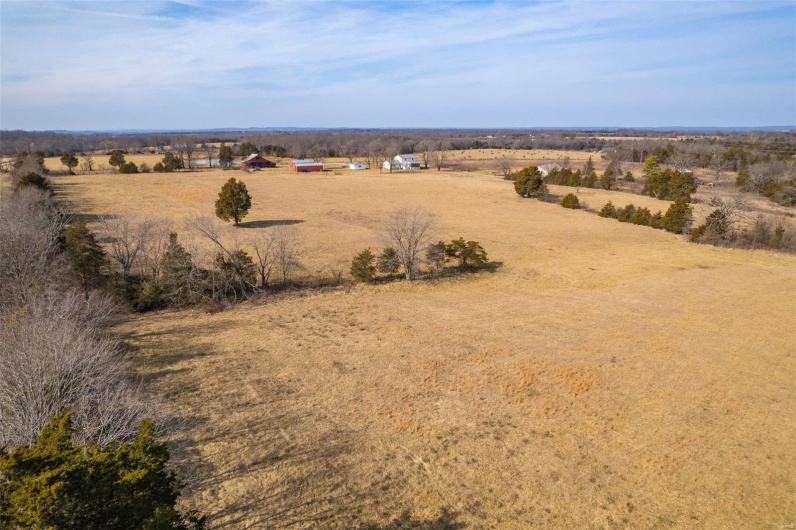 Birds eye view of property featuring a rural view
