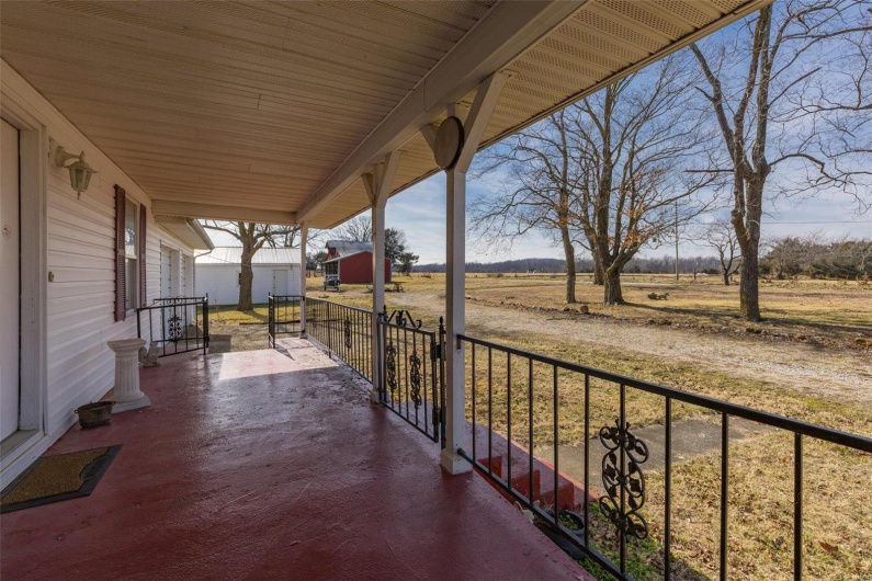 Balcony with a rural view and covered porch