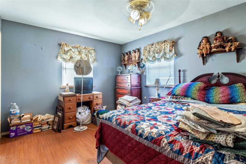 Bedroom featuring ceiling fan and hardwood / wood-style floors