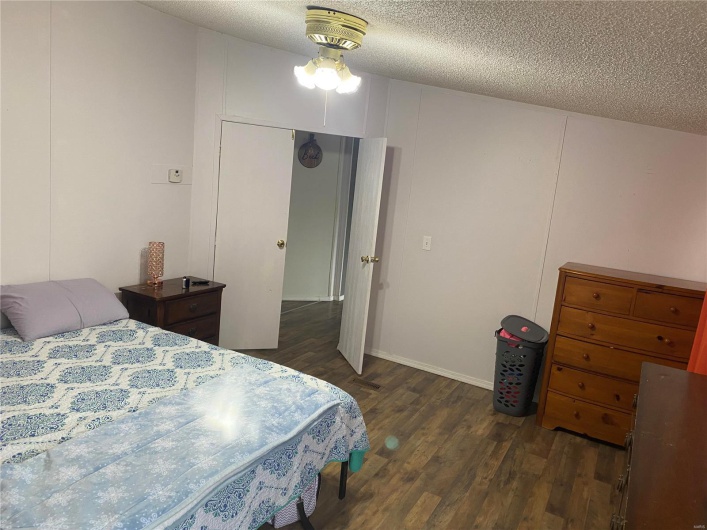 Bedroom featuring dark hardwood / wood-style floors and a textured ceiling