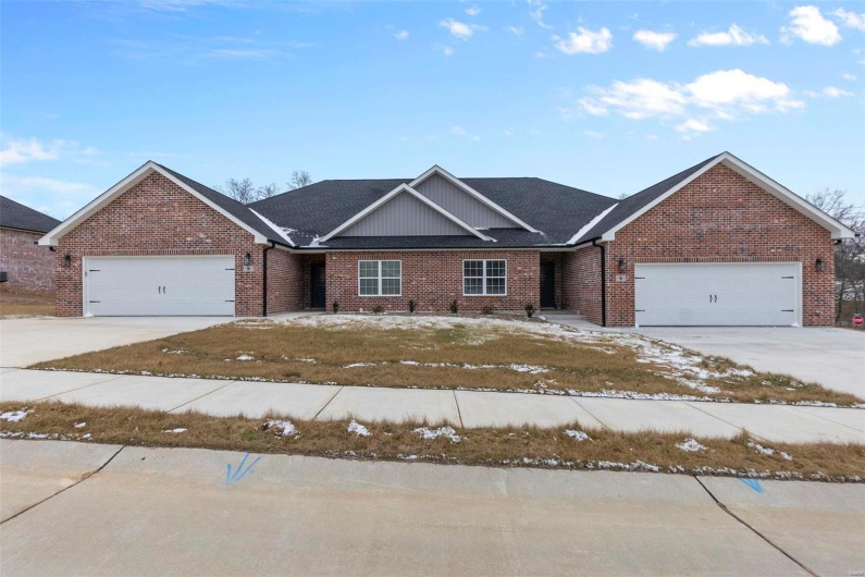 View of front of house featuring a front yard and a garage