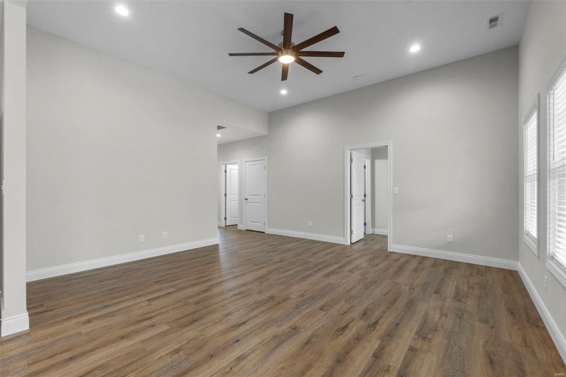 Spare room with ceiling fan and dark wood-type flooring